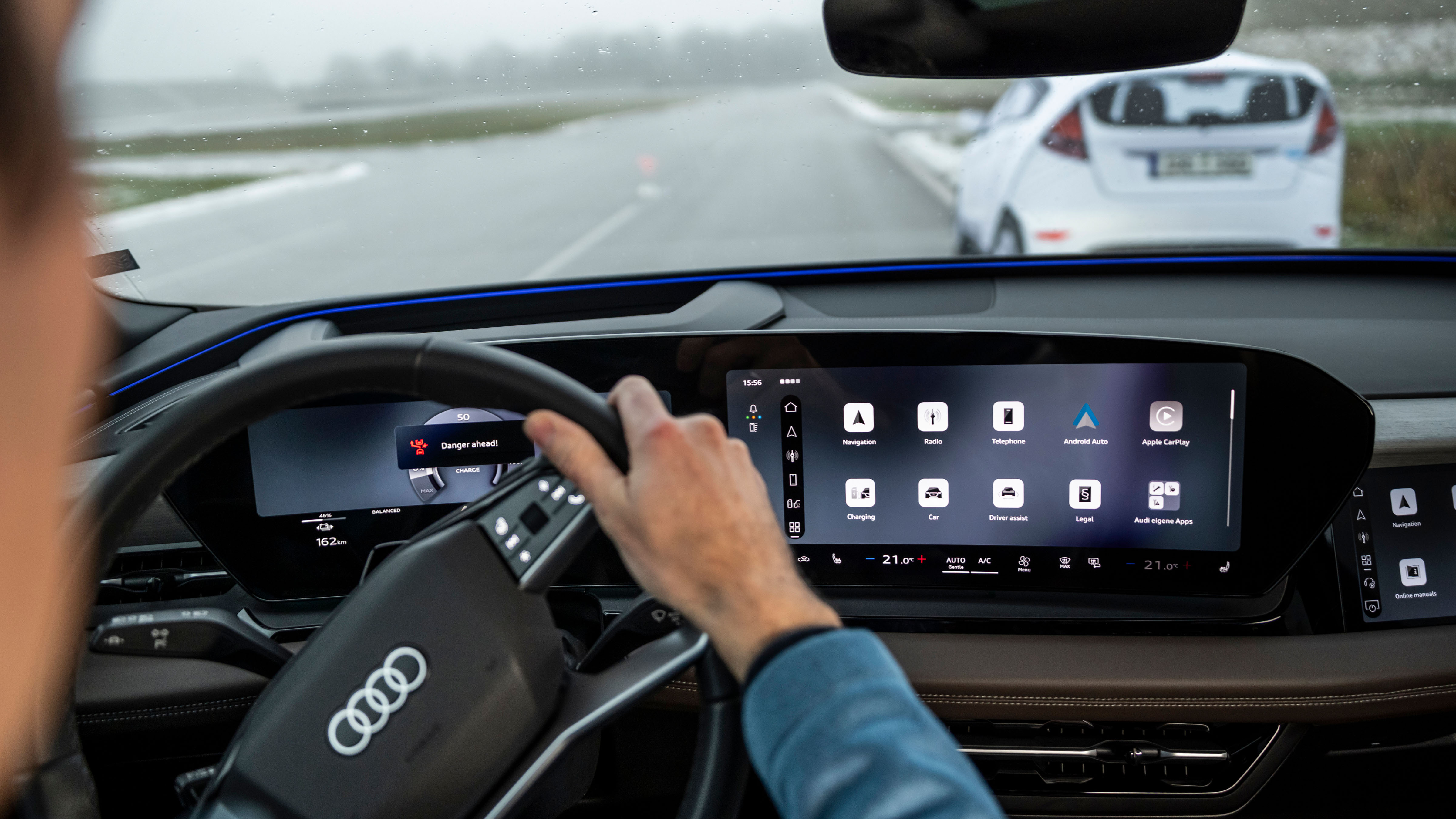 Cockpit view with warning notification, driver perspective, and a stationary vehicle ahead—depicting a real-world emergency steering scenario.