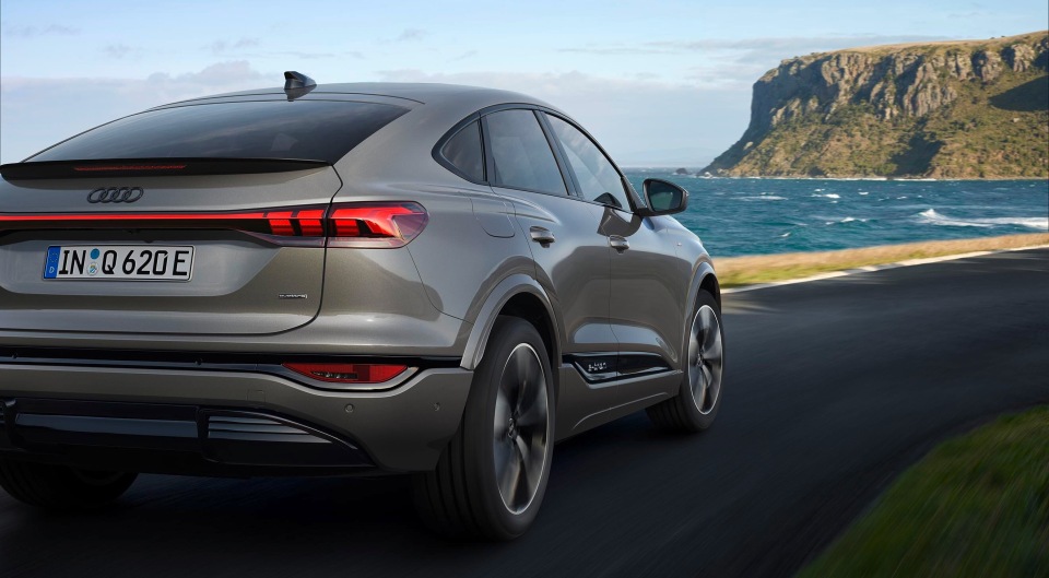 Audi Q4 e-tron on a scenic coastal drive.