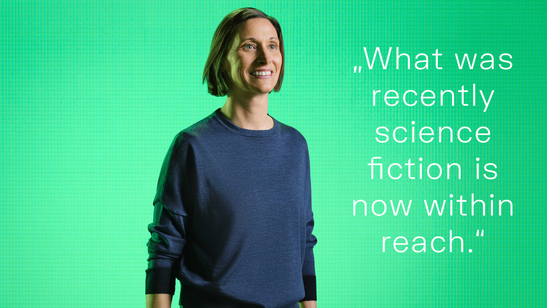 Person in blue shirt standing against green background with text 'What was recently science fiction is now within reach