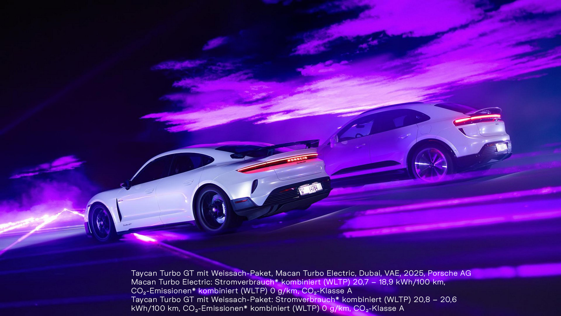 Two white Porsche sports cars—Taycan Turbo GT with Weissach Package and Macan Turbo Electric—driving on a road with purple lighting in Dubai, 2025