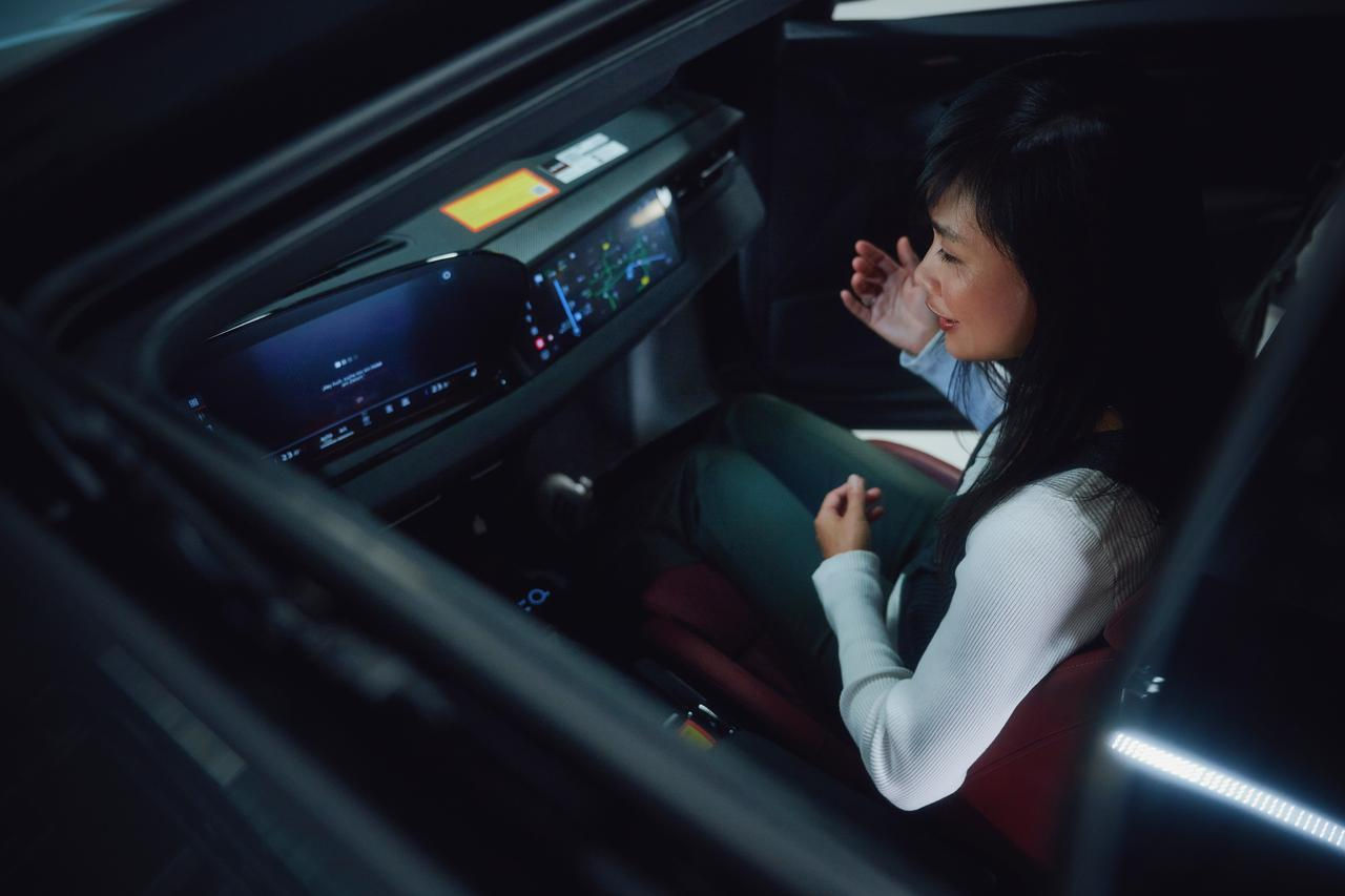 A female driver sits at the helm of a modern vehicle, surrounded by a sleek dashboard and digital control panel—highlighting the fusion of comfort and technology.